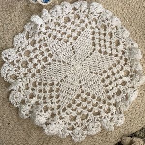Two crochet doilies, 14” and 10” white, and white blue and violet.